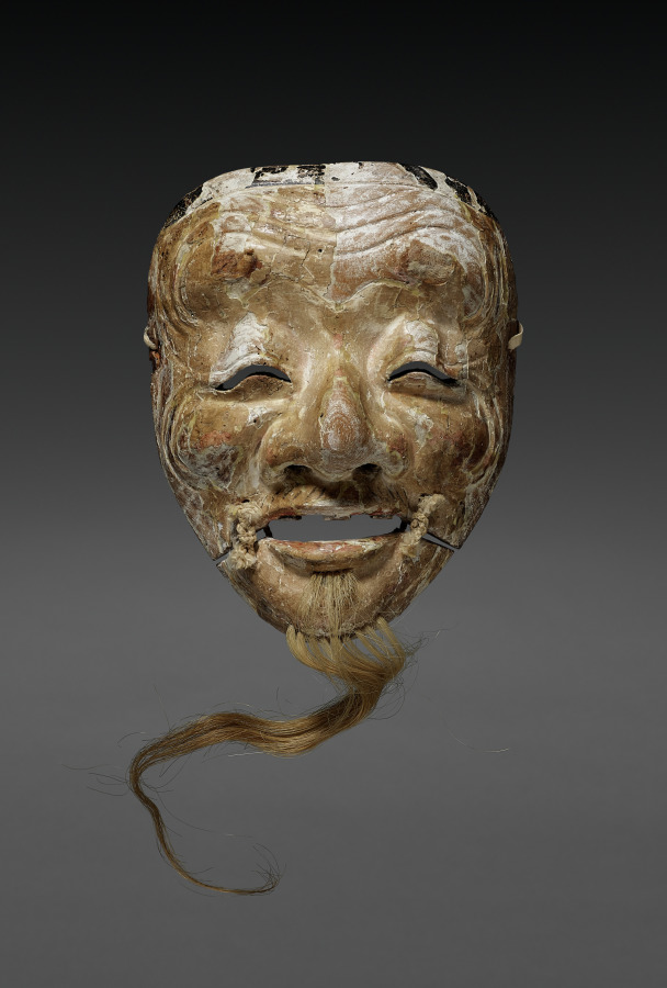 Noh Mask of Okina by Unknown Artist (1400), polychromed wood and hemp at Cleveland Museum of Art