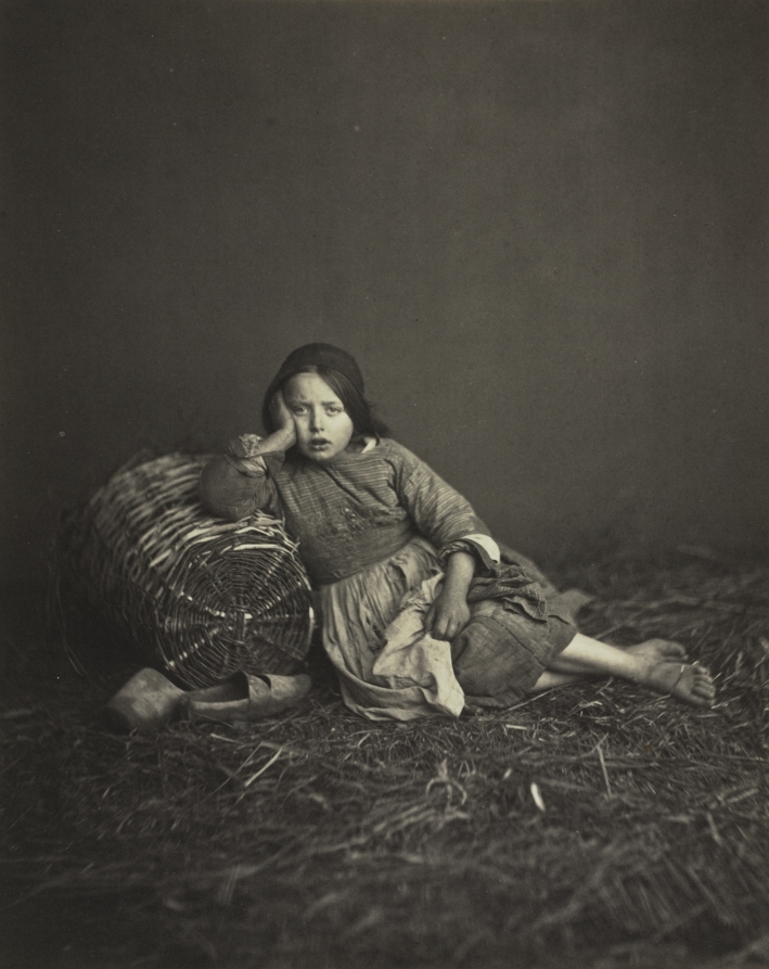 Young Girl Seated on Straw, Leaning on a Basket